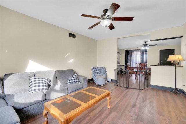 living room with hardwood / wood-style floors and ceiling fan