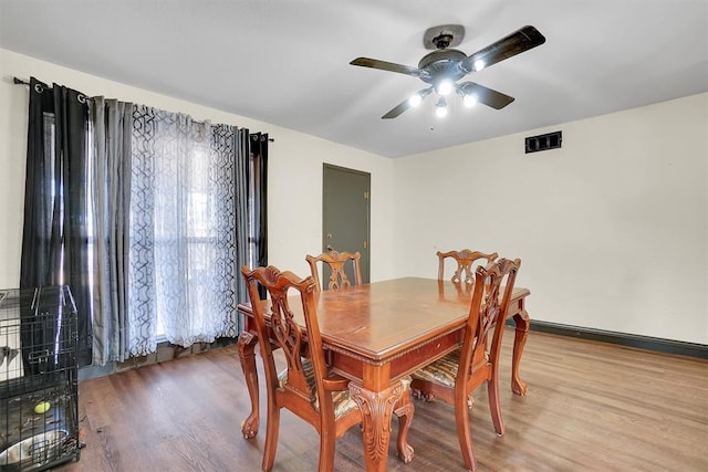 dining room with ceiling fan and hardwood / wood-style flooring