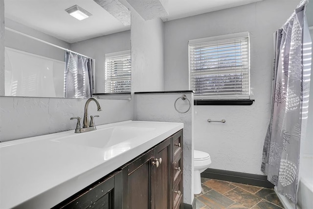 full bathroom with vanity, toilet, and shower / tub combo