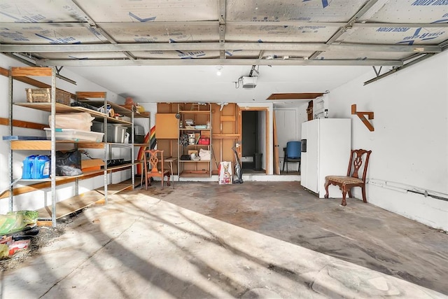 garage featuring a garage door opener and white fridge with ice dispenser