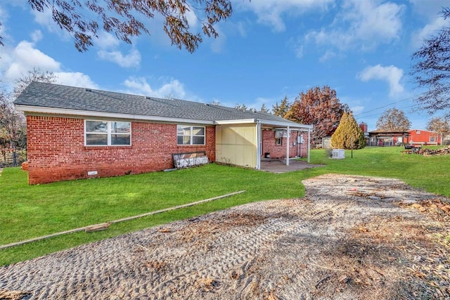 back of property featuring a patio area and a yard