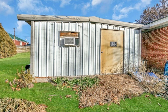 view of outdoor structure featuring a yard and cooling unit