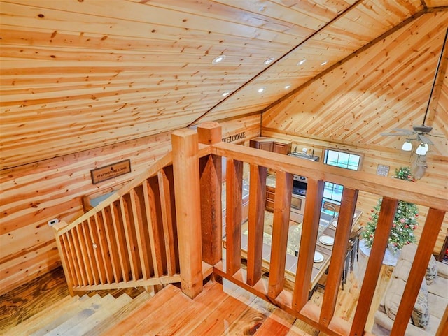 stairs featuring wood-type flooring, lofted ceiling, and wooden ceiling