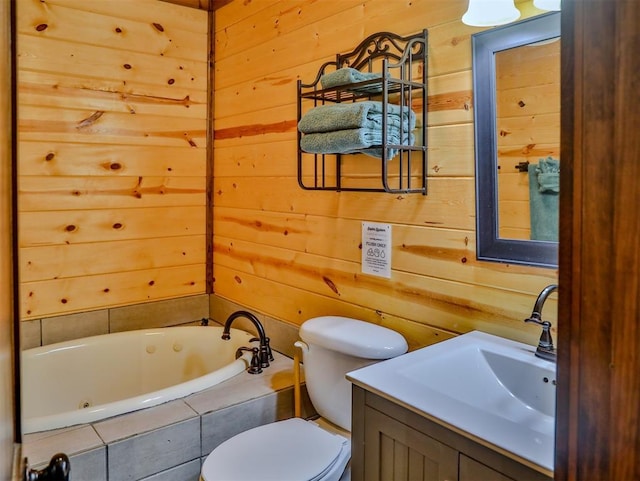 bathroom featuring vanity, a relaxing tiled tub, toilet, and wooden walls