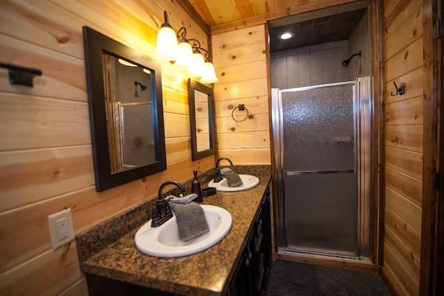 bathroom featuring wood walls, a shower with door, vanity, and wooden ceiling