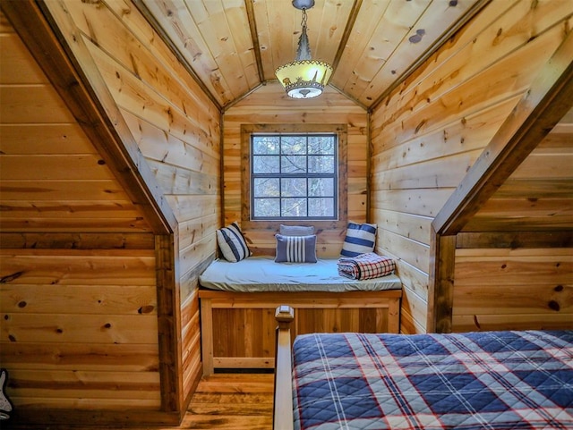 unfurnished bedroom featuring wood-type flooring, lofted ceiling, wooden walls, and wooden ceiling