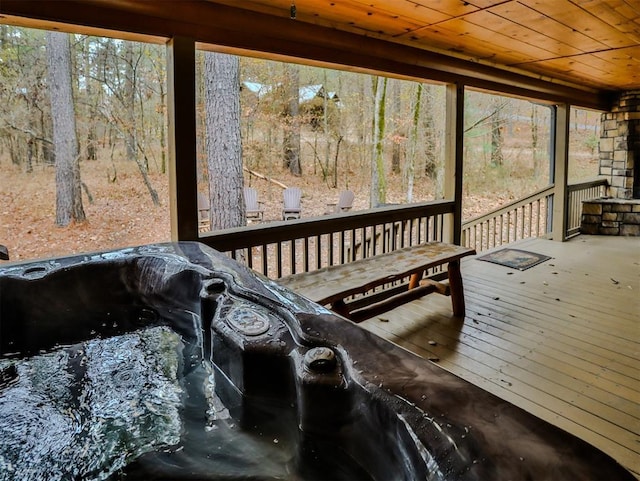 sunroom featuring plenty of natural light, wooden ceiling, and a hot tub