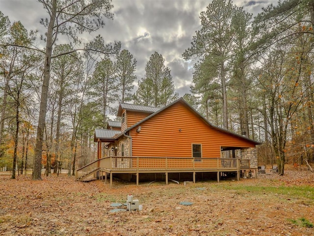 view of property exterior featuring a wooden deck