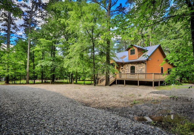 527 High Peak Trl, Broken Bow, OK 74728 - view of side of home featuring stone siding, view of wooded area, and log veneer siding