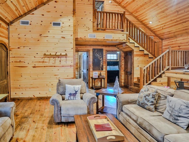 527 High Peak Trl, Broken Bow, OK 74728 - living room featuring wood ceiling, wooden walls, hardwood / wood-style floors, stairs, and high vaulted ceiling