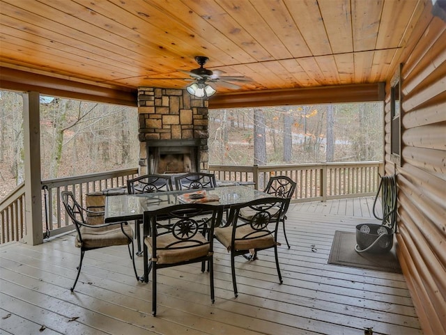 527 High Peak Trl, Broken Bow, OK 74728 - sunroom featuring an outdoor stone fireplace, outdoor dining area, and ceiling fan