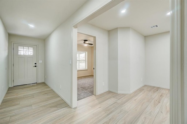 foyer with ceiling fan, light wood-type flooring, and a wealth of natural light