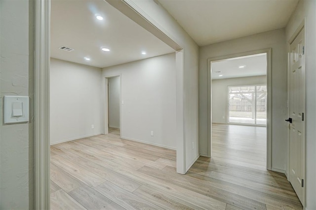 empty room with light hardwood / wood-style flooring