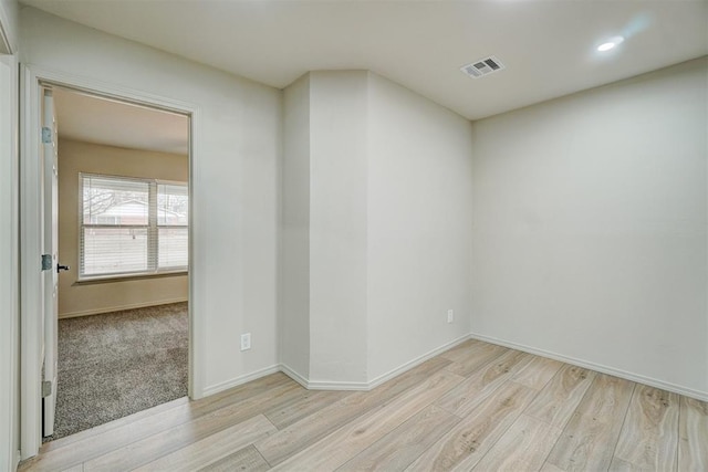 unfurnished room featuring light hardwood / wood-style floors