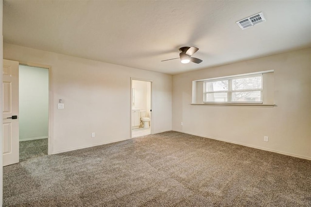 carpeted spare room with ceiling fan