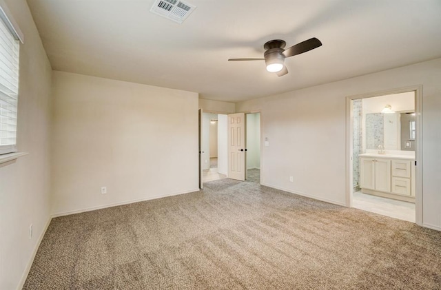 empty room featuring ceiling fan, light colored carpet, and sink