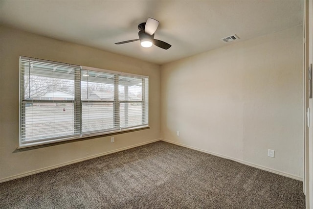 spare room with carpet, ceiling fan, and plenty of natural light