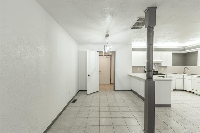 kitchen featuring sink, decorative light fixtures, stainless steel electric range, dishwasher, and white cabinets