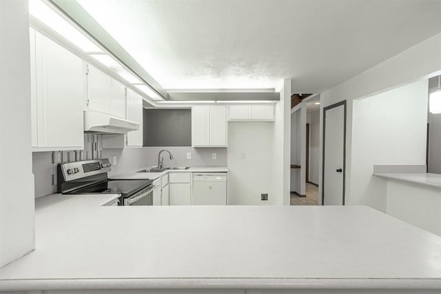 kitchen with stainless steel electric range oven, white cabinetry, sink, white dishwasher, and kitchen peninsula