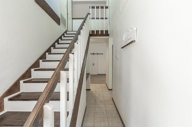 staircase with tile patterned floors