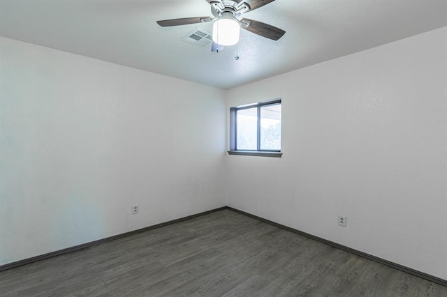 unfurnished room with ceiling fan and dark hardwood / wood-style floors