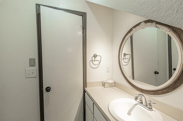 bathroom with vanity and a textured ceiling