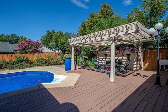 view of swimming pool with a wooden deck and a pergola