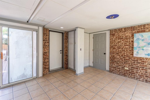 unfurnished room with brick wall