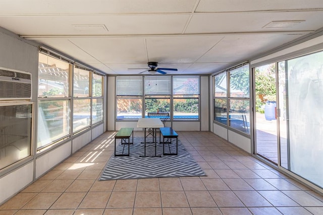 sunroom with a wall mounted air conditioner and ceiling fan