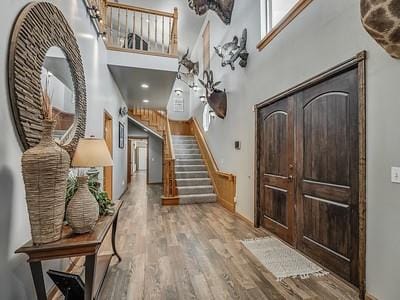 foyer entrance featuring a high ceiling and light wood-type flooring