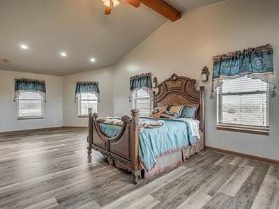 bedroom with beamed ceiling, ceiling fan, wood-type flooring, and high vaulted ceiling