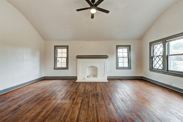 unfurnished living room with dark hardwood / wood-style flooring, ceiling fan, plenty of natural light, and lofted ceiling