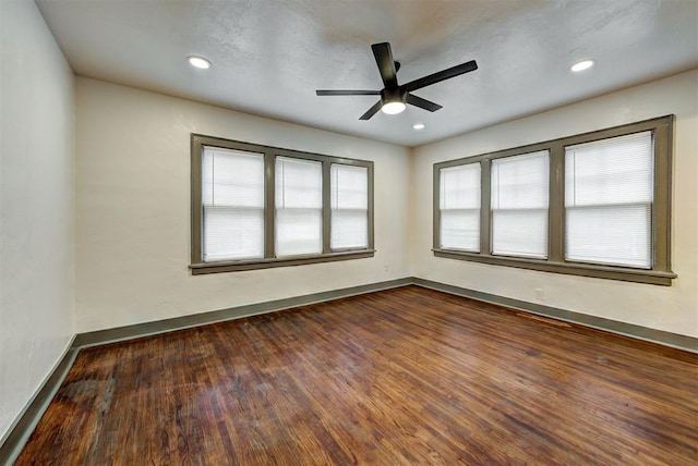 spare room with ceiling fan and dark wood-type flooring