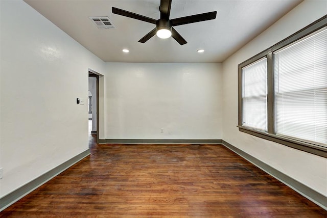 unfurnished room featuring dark hardwood / wood-style flooring and ceiling fan