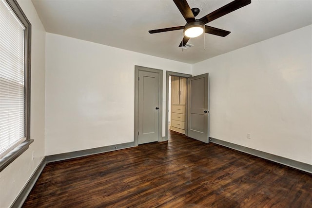 unfurnished bedroom featuring dark hardwood / wood-style flooring and ceiling fan