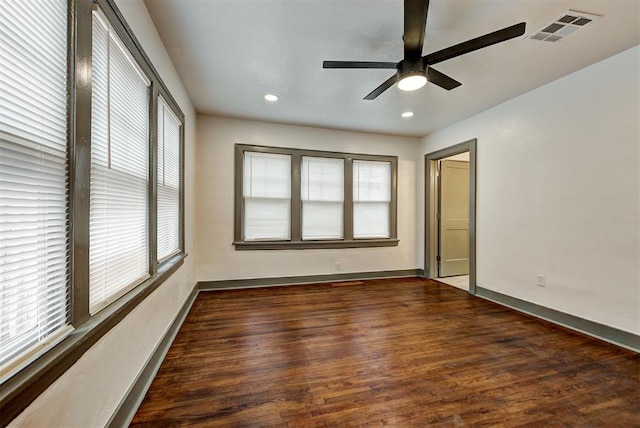 empty room with baseboards, visible vents, dark wood-style floors, ceiling fan, and recessed lighting