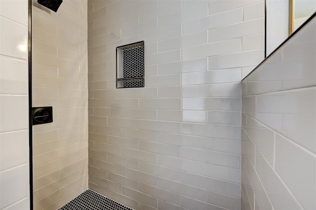 bathroom with tiled shower