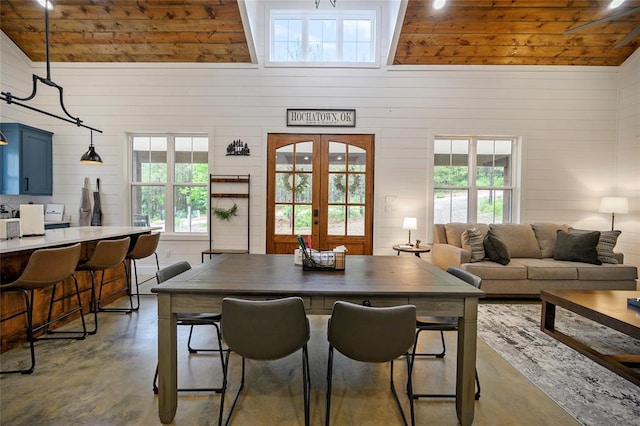 dining room with wooden ceiling, high vaulted ceiling, and french doors