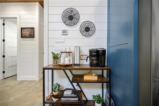 interior details with wood walls and concrete flooring