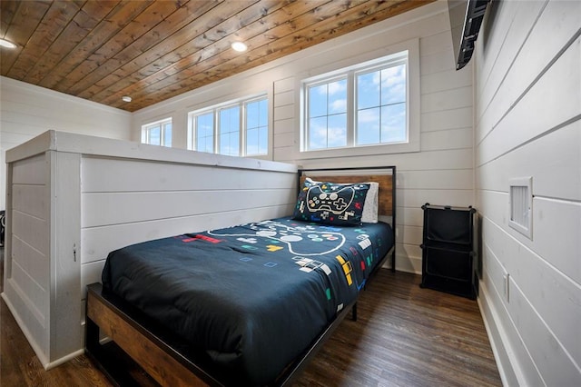 bedroom with dark hardwood / wood-style flooring, multiple windows, wood walls, and wood ceiling