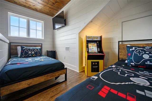 bedroom featuring wood-type flooring, vaulted ceiling, wooden ceiling, and wood walls