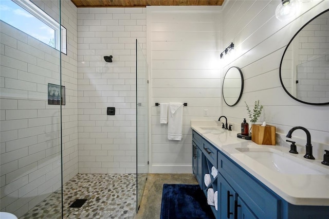 bathroom featuring vanity, wooden walls, and a shower with shower door