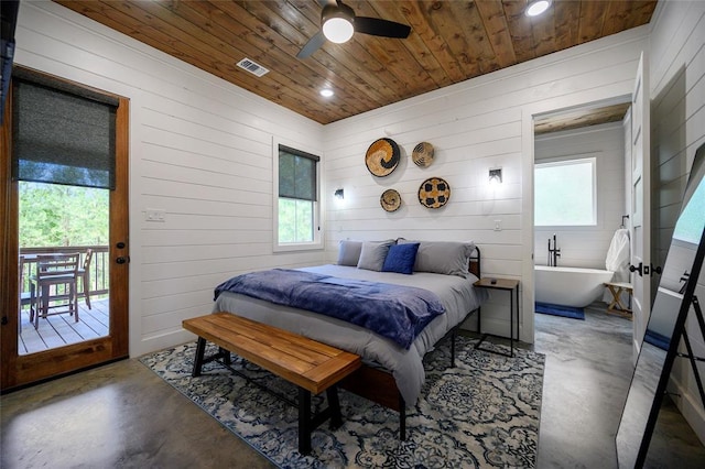 bedroom featuring concrete floors, multiple windows, and ceiling fan