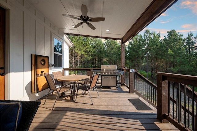 wooden terrace with grilling area and ceiling fan