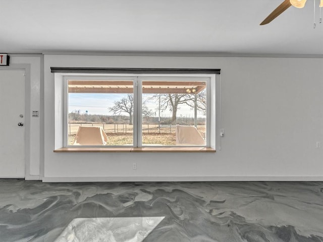 unfurnished room with ceiling fan and a healthy amount of sunlight