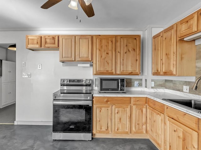 kitchen with light brown cabinetry, sink, ceiling fan, and stainless steel electric range