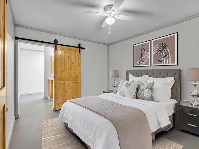 bedroom with ceiling fan, a barn door, concrete flooring, and crown molding