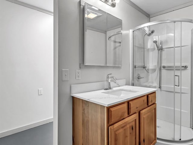 bathroom with vanity and a shower with shower door