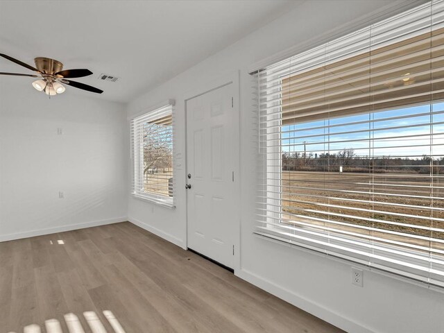 foyer entrance featuring ceiling fan and light hardwood / wood-style flooring