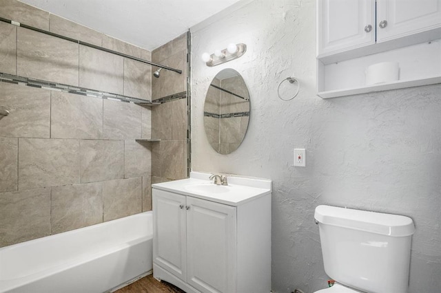 full bathroom with vanity, toilet, and tiled shower / bath